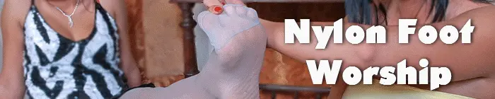 Woman worshipping her girlfriend's nyloned feet